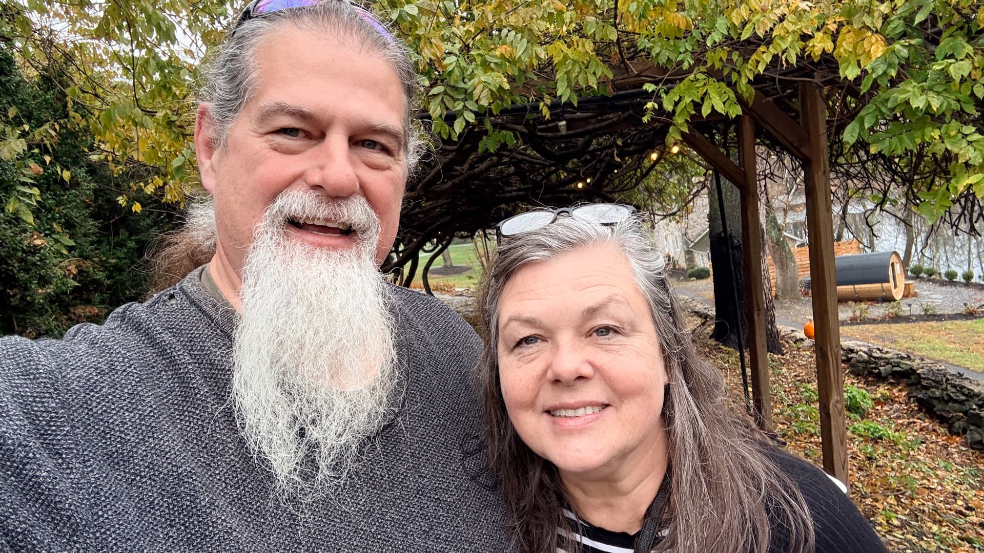 Vernon and Shelley Hyndman together under a pergola of autumn leaves, their 40th anniversary